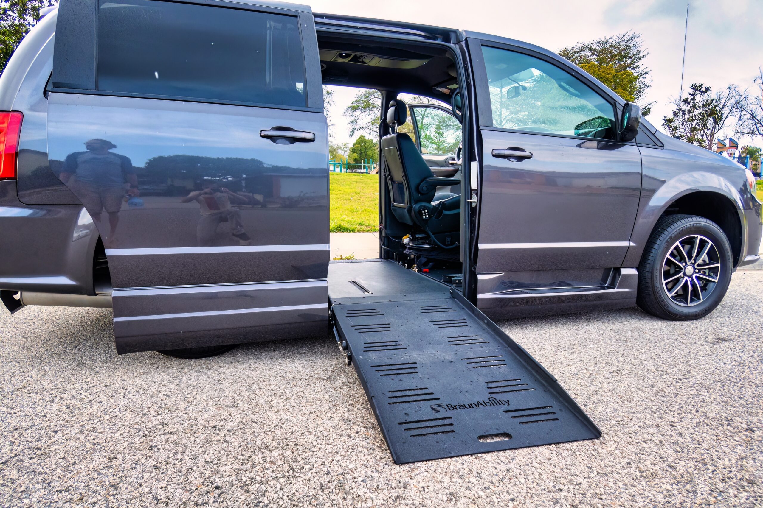 Professional driver safely securing wheelchair in ADA-compliant vehicle in West Hartford